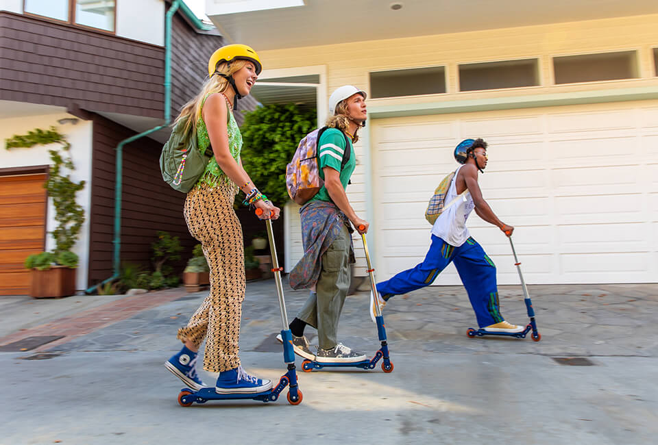 3 teenagers riding their Valor scooters